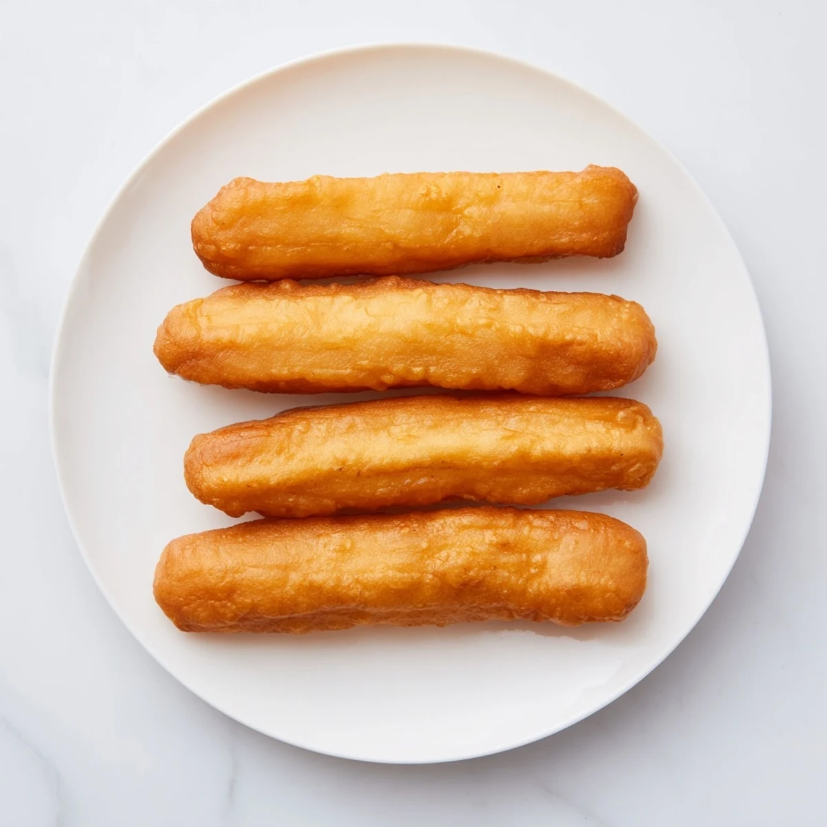 Crispy outside, fluffy inside Youtiao sticks ready for dipping in soy milk