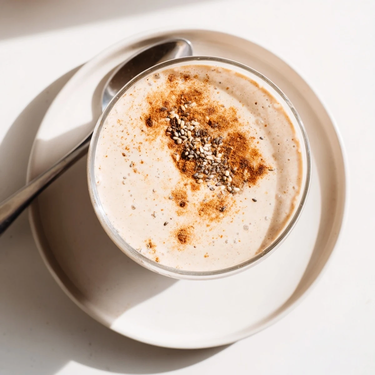 Thick Greek yogurt banana smoothie topped with fresh banana slices and a sprinkle of cinnamon