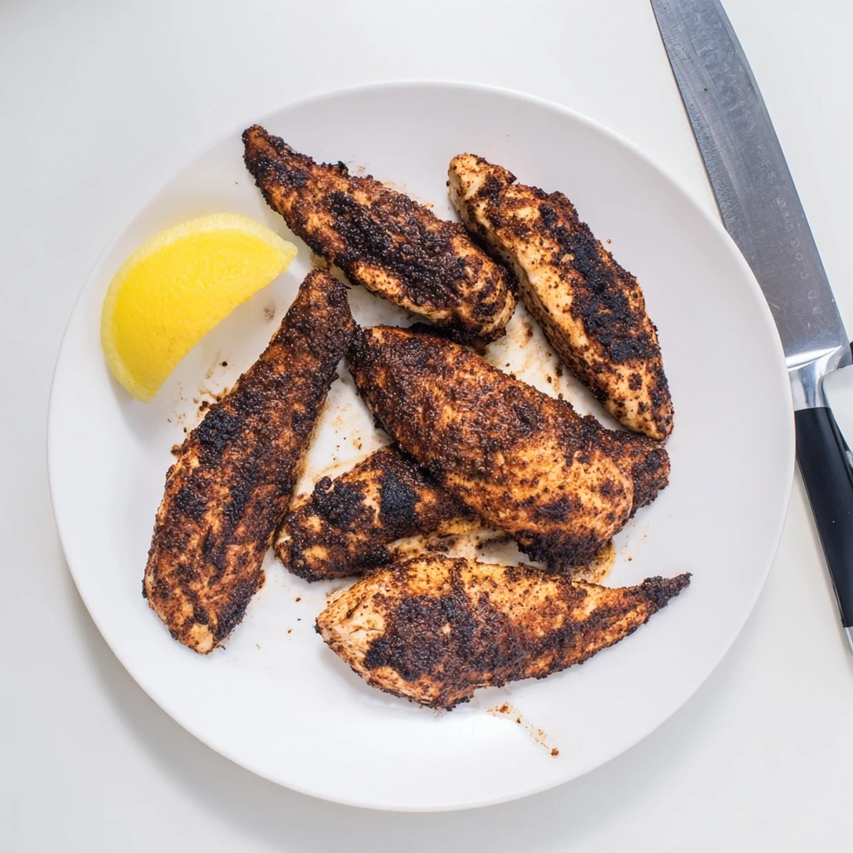 Perfectly cooked blackened chicken displaying caramelized seasoning and tender white meat interior