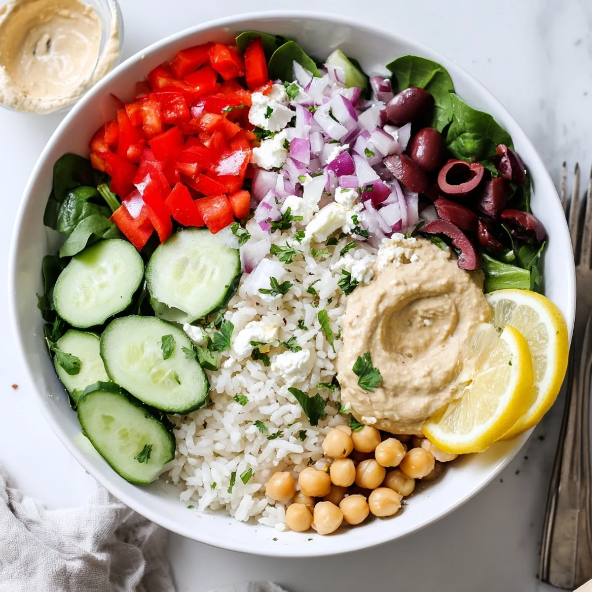 Fluffy rice surrounded by crisp cherry tomatoes, cucumbers, and bell peppers in this vibrant Mediterranean rice bowl