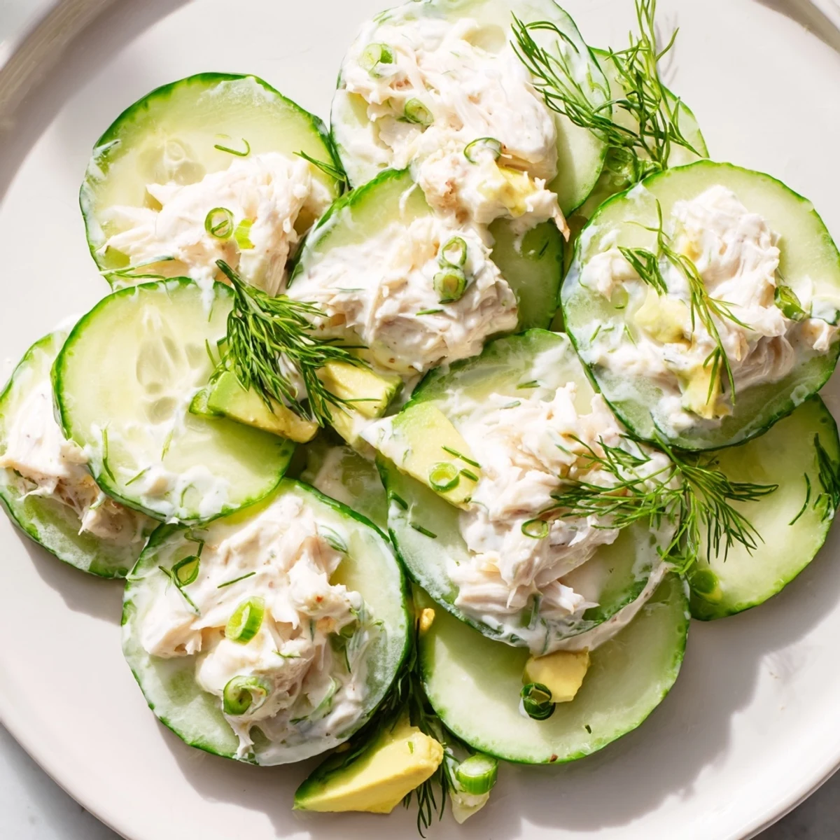 Chilled cucumber salad with crab meat featuring tender seafood and thinly sliced vegetables