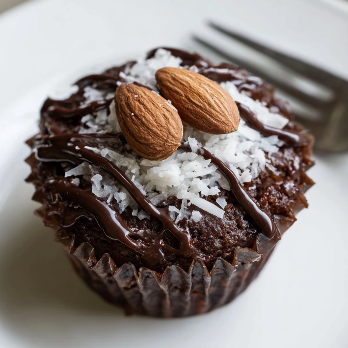 Decadent flourless almond joy cupcakes with gooey coconut centers on a rustic wire cooling rack