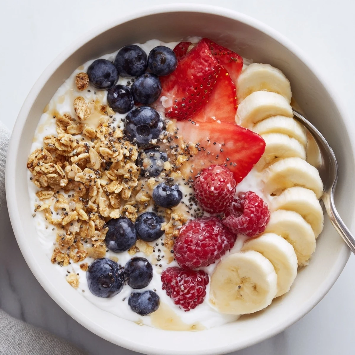 Bright Cottage Cheese Breakfast Bowl topped with sliced banana and honey.