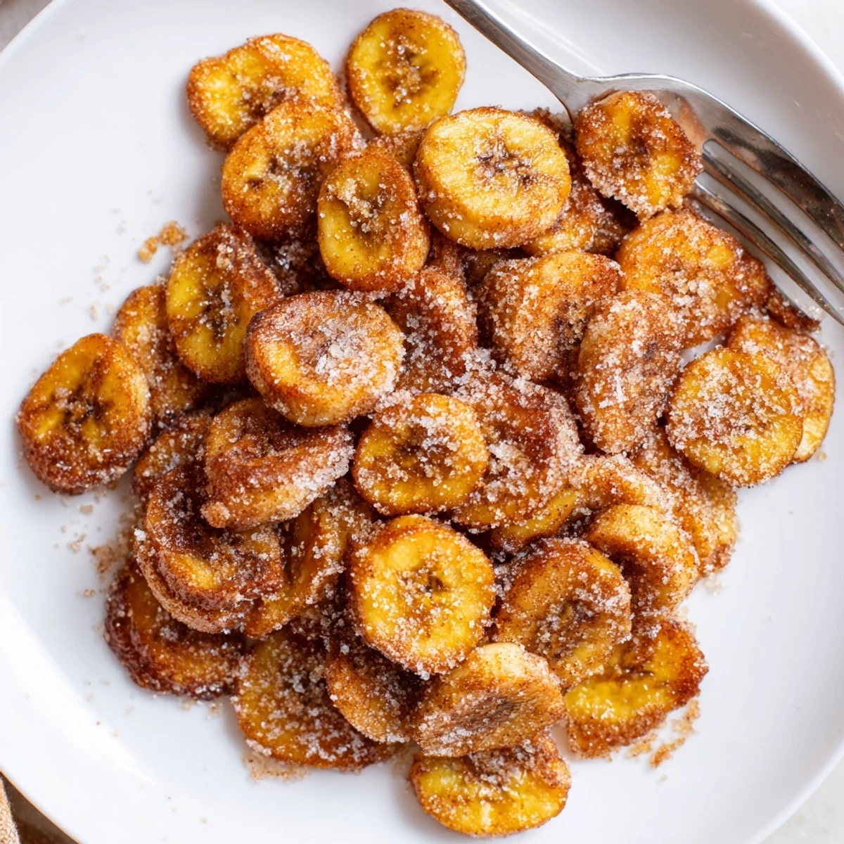 Closeup of Crispy Cinnamon Sugar Air Fryer Banana Chips golden crunchy slices