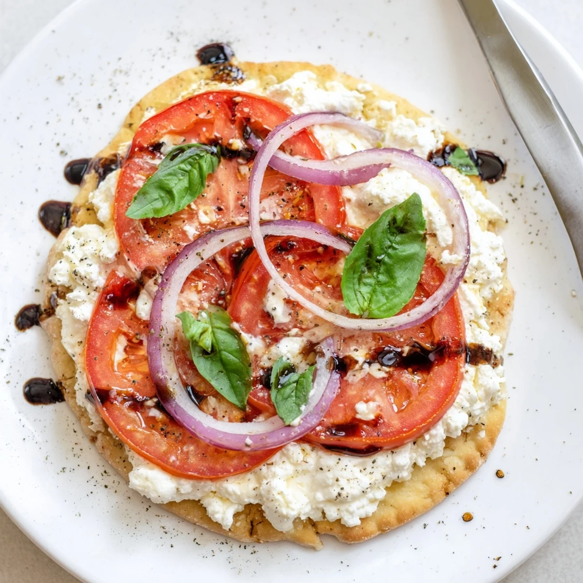 Warm Caprese Pita Pizza With Whipped Garlic Feta, melty mozzarella and basil