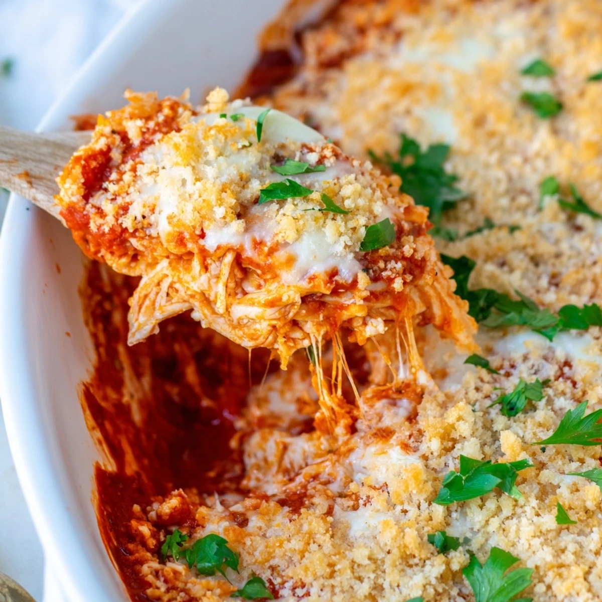 Golden Chicken Parmesan casserole with bubbling mozzarella and crispy buttered panko breadcrumb topping