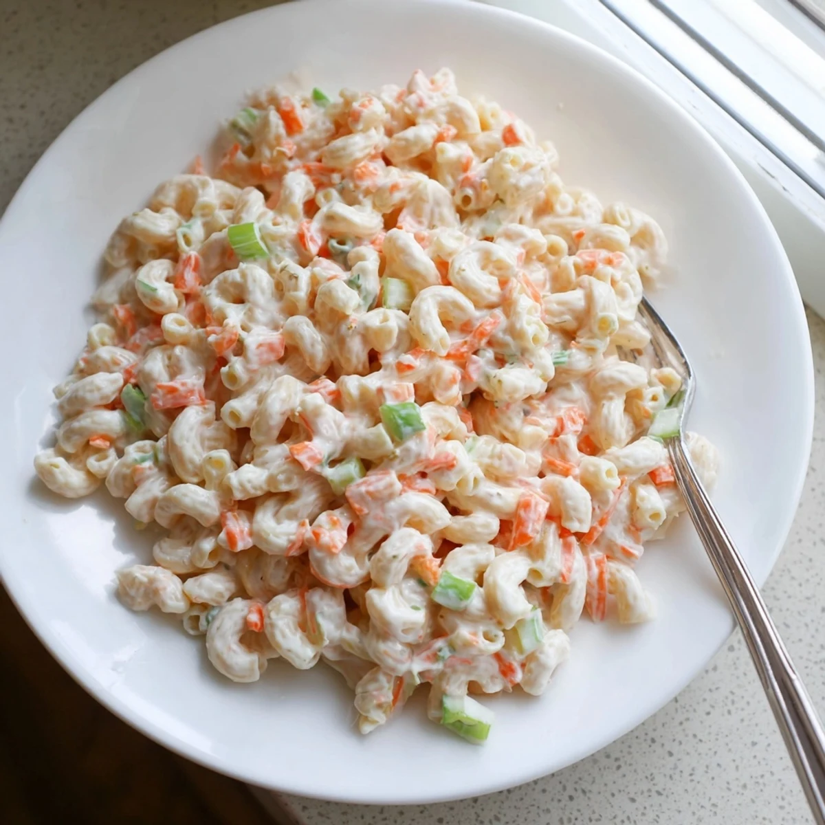 Creamy Hawaiian style mac salad loaded with tender pasta and crisp colorful vegetables in a rich mayonnaise dressing