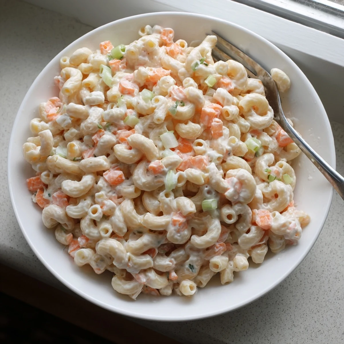 Golden macaroni tossed in tangy homemade dressing with grated carrots and celery for authentic Hawaiian style mac salad