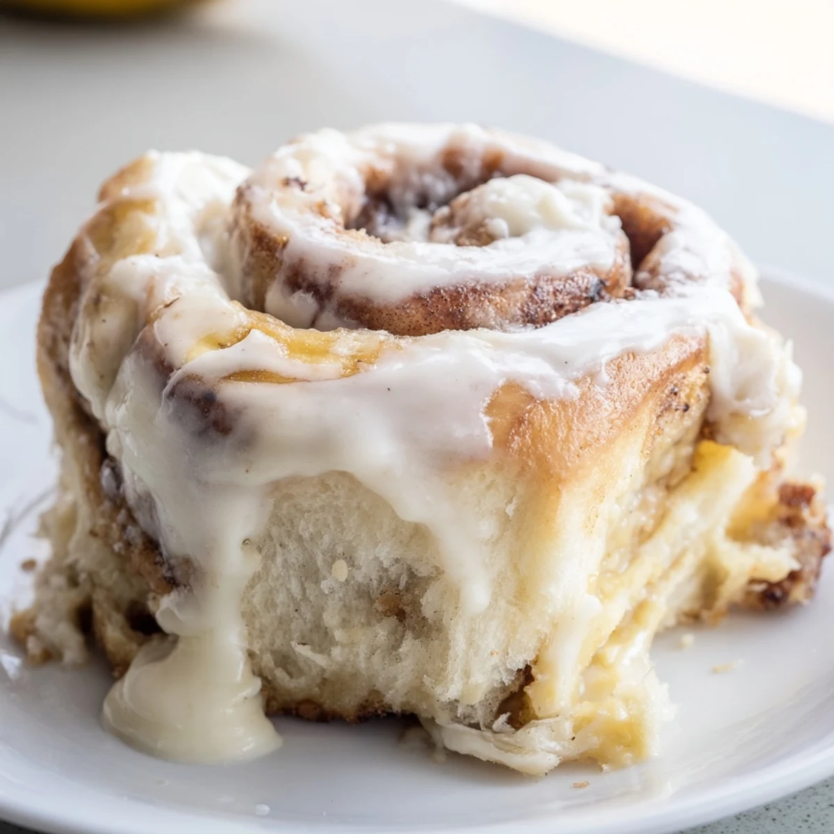 Warm banana cinnamon rolls burst with ripe banana slices under a velvety vanilla glaze