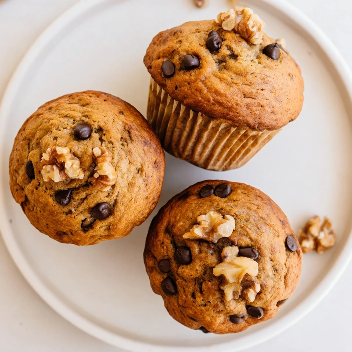 Golden banana espresso chocolate chip muffins fresh from the oven with melted chocolate swirls