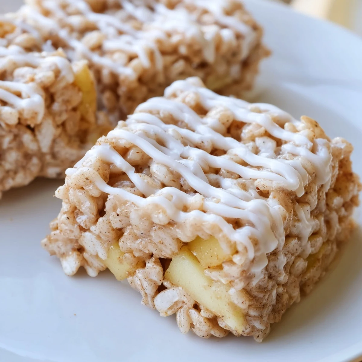 Square pan of warm apple pie rice krispie treats cut into neat portions