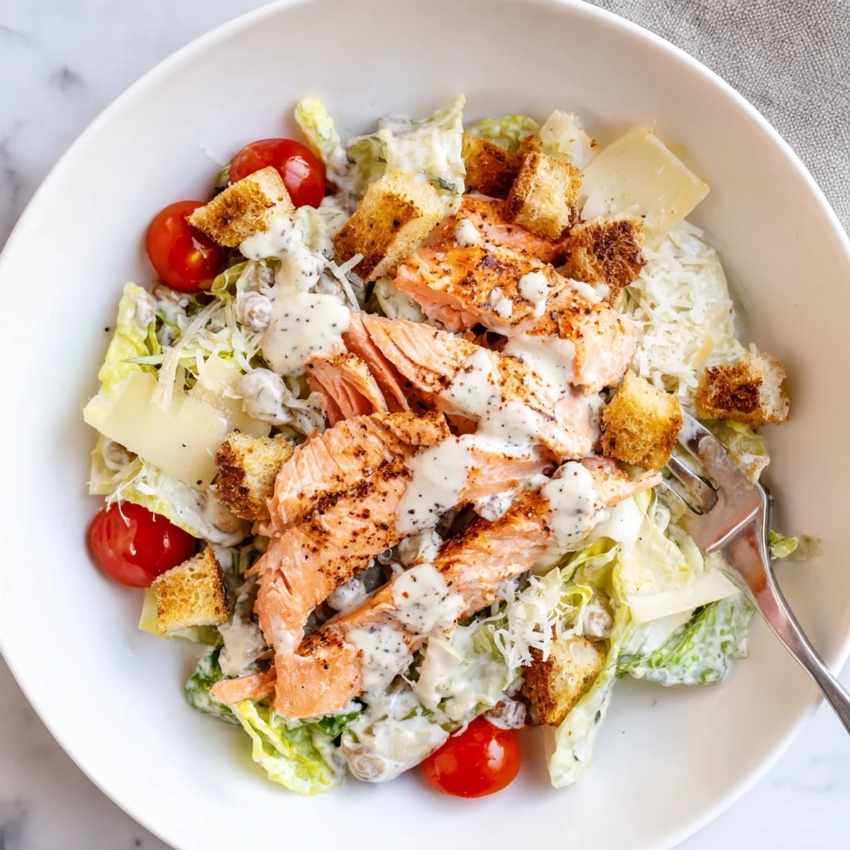 Creamy Smoky Salmon Caesar Salad Recipe tossed with homemade dressing and croutons