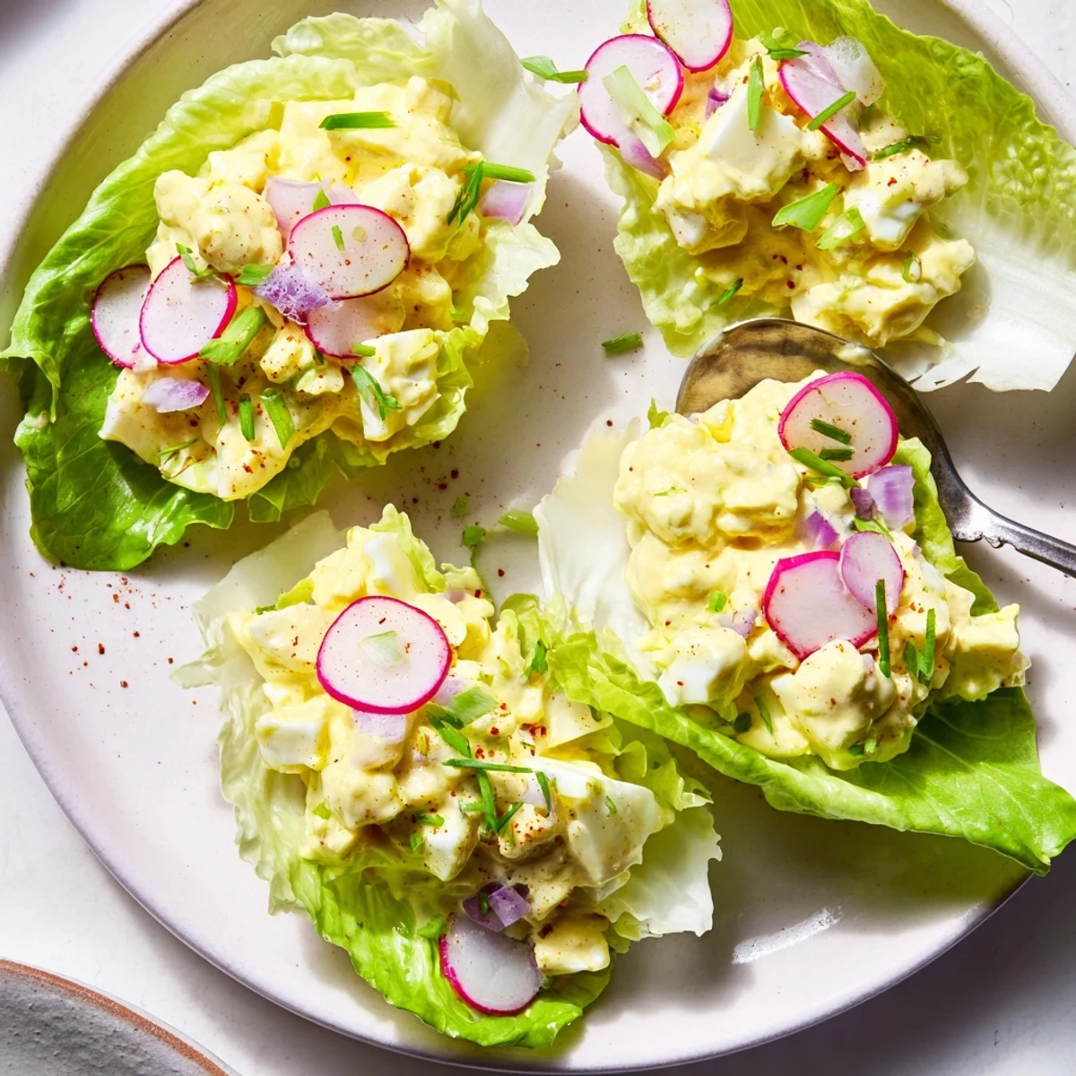 Crisp Egg Salad Lettuce Wraps piled on platter, creamy filling, fresh herbs