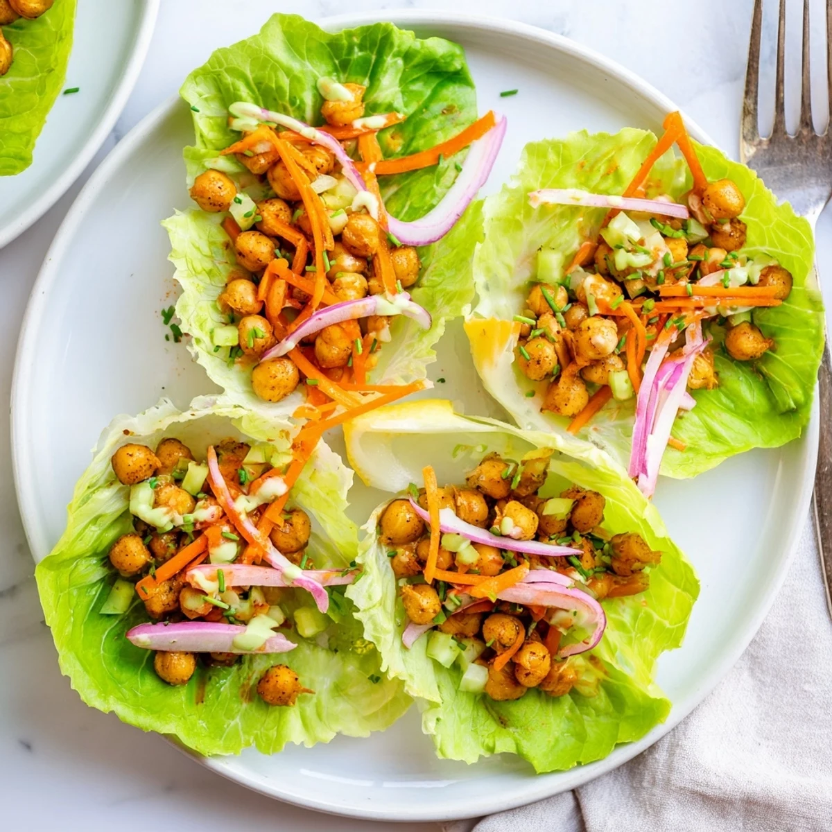 Cooling ranch drizzled over Buffalo Chickpea Lettuce Wraps with crunchy carrots  