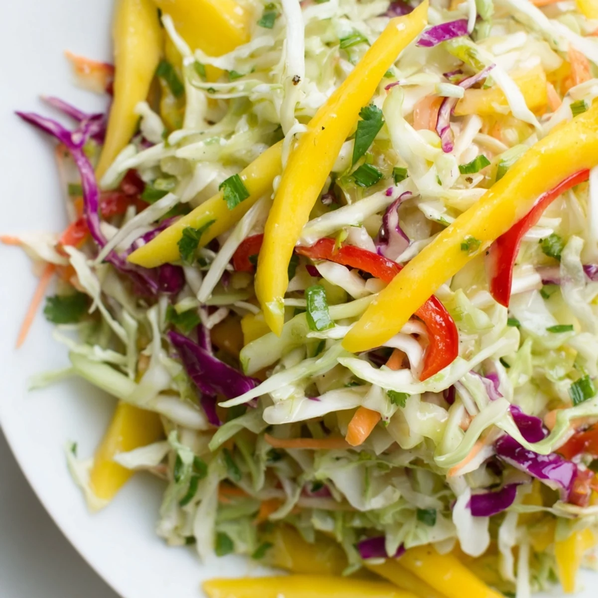 Bright Mango Cabbage Citrus Slaw glistening with citrus dressing, crisp textures