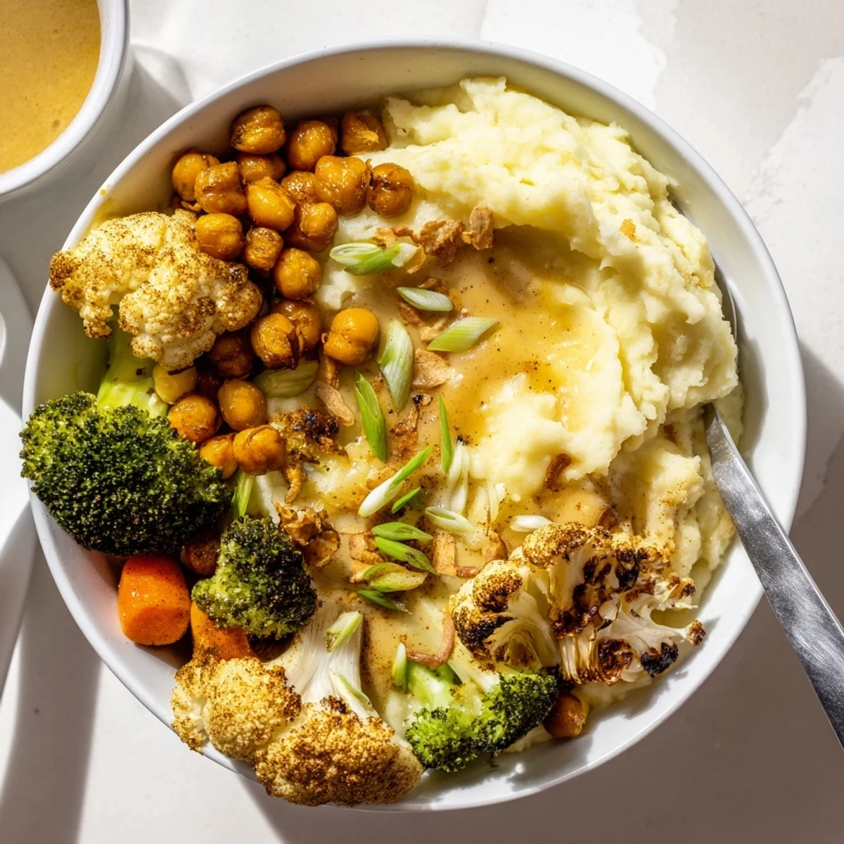 Creamy Vegan Mashed Potato Bowls topped with crispy chickpeas and fresh chives