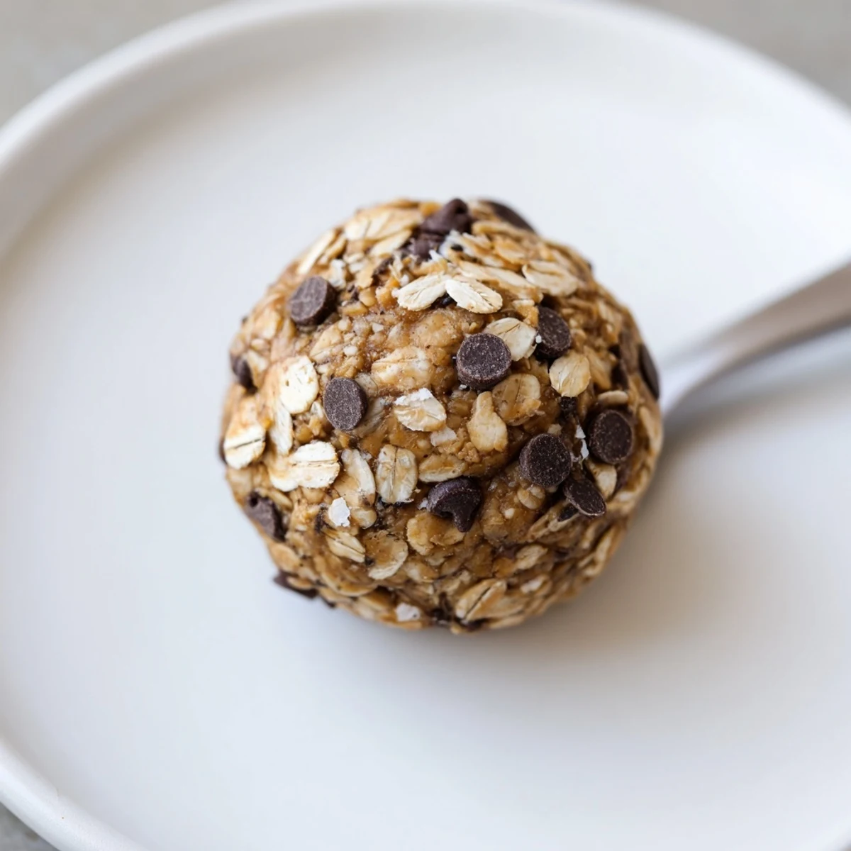 Stack of No Bake Energy Balls chilling on parchment, nutty, slightly sticky