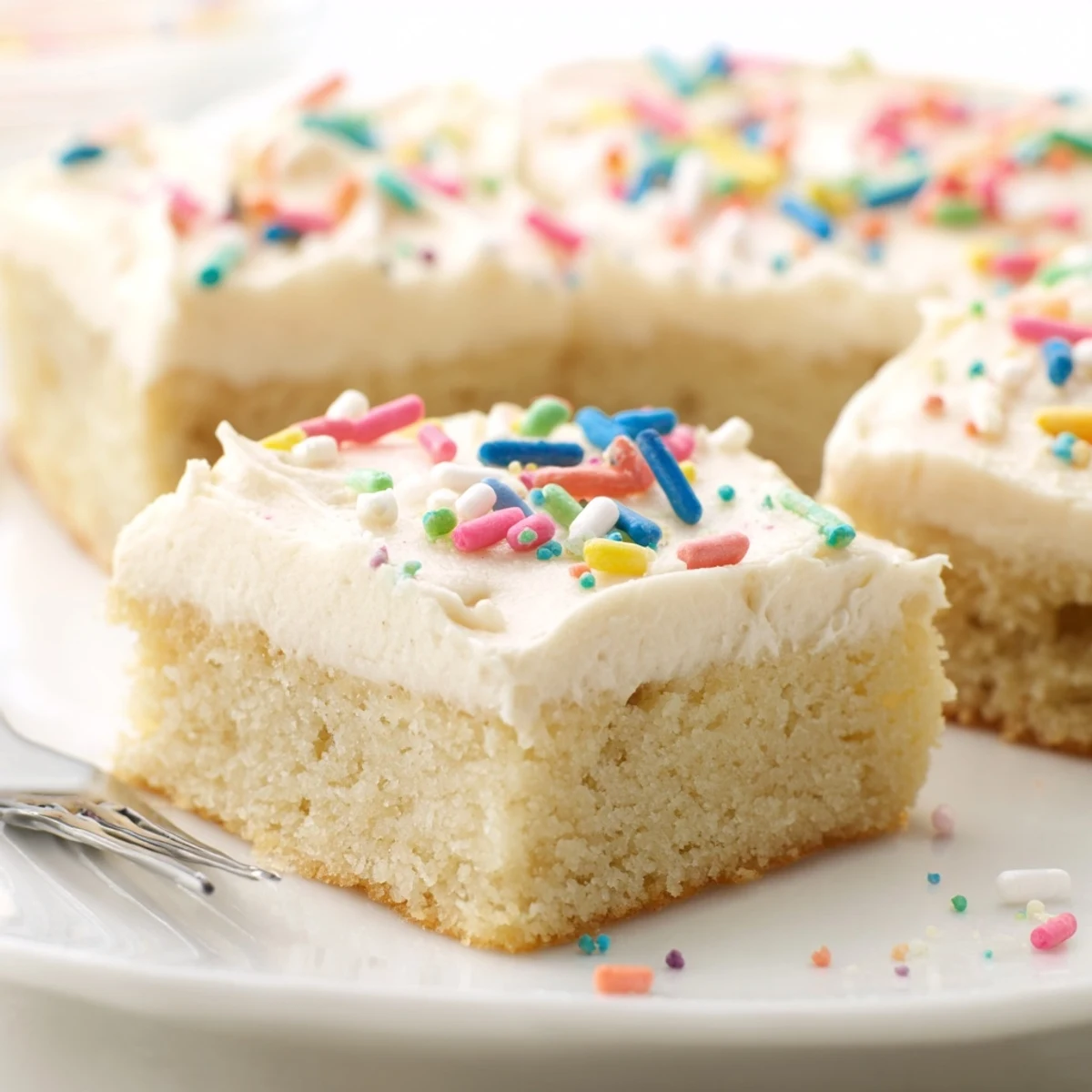 Close-up of Frosted Sugar Cookie Bars Recipe showing glossy frosting and colorful sprinkles
