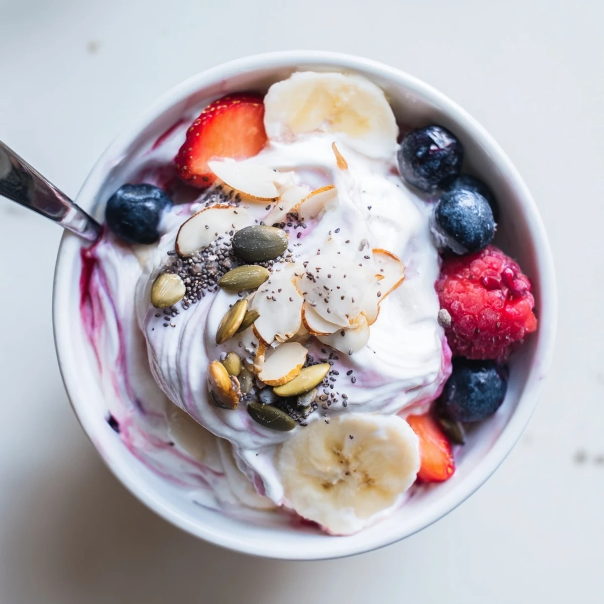 Bright High Protein Greek Yogurt Bowl served for breakfast with seeds and fruit garnish