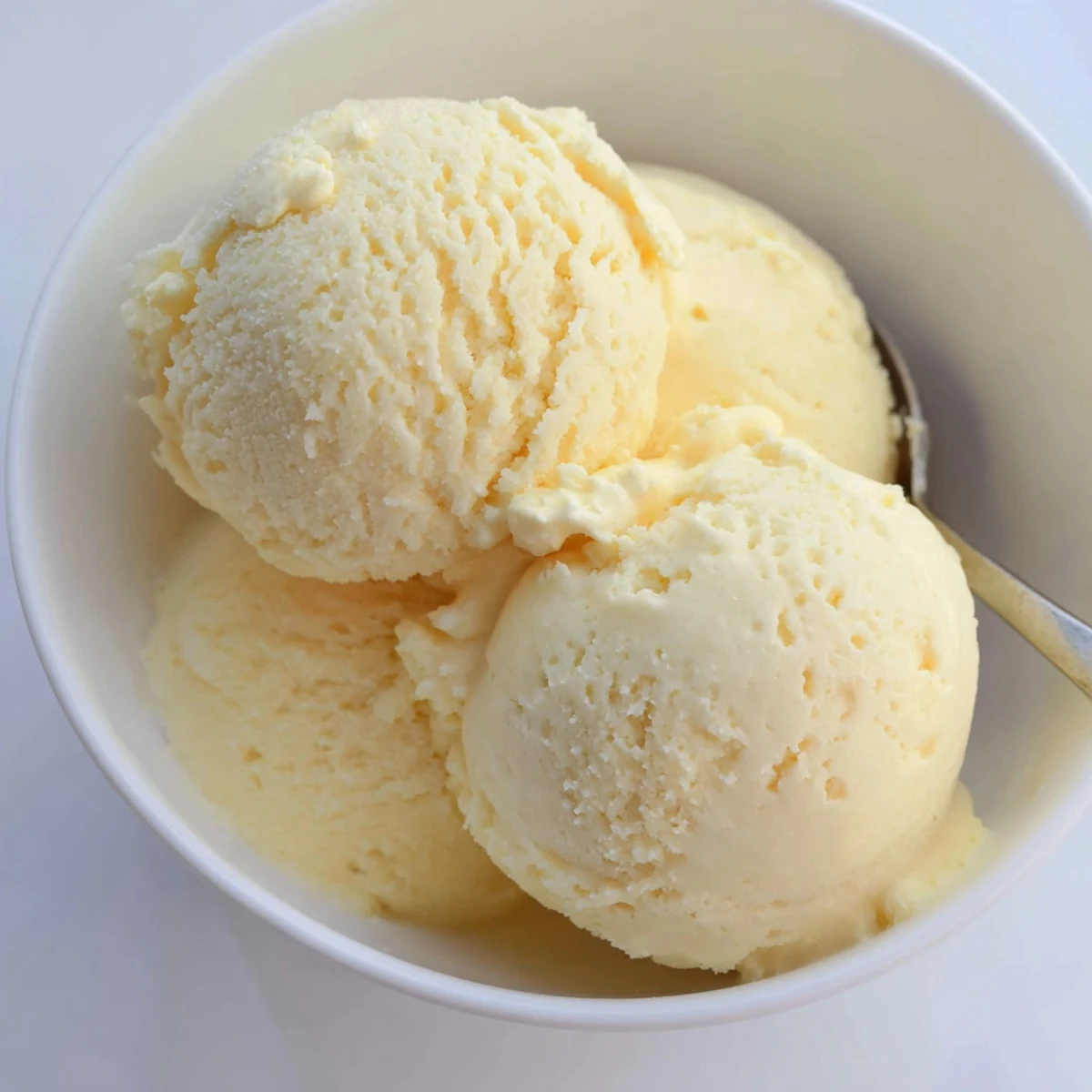 Rich vanilla ice cream with luscious swirls served in a vintage waffle cone on a sunny afternoon