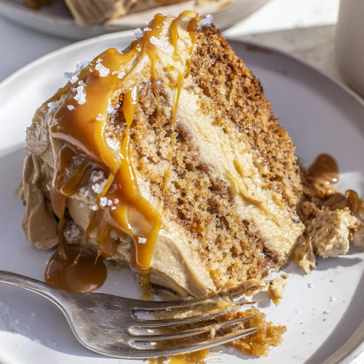 Decadent layered brown butter banana cake topped with creamy salted caramel and sea salt flakes