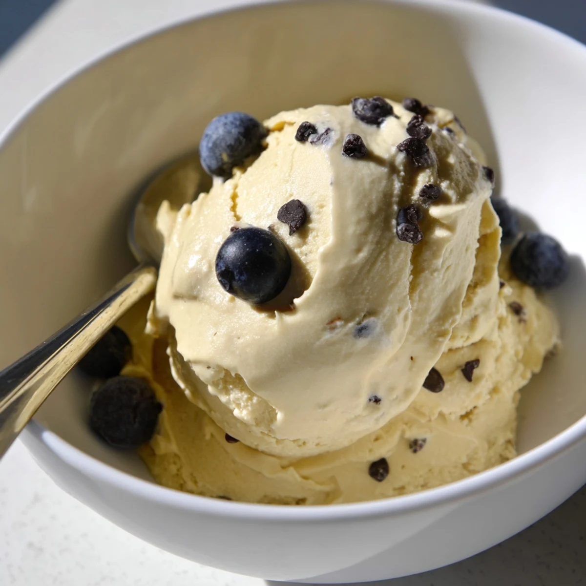 Dairy-free banana nice cream recipe scooped into glasses showing smooth soft serve texture