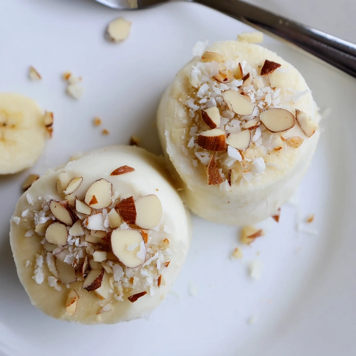 Hand picking Frozen Banana Yogurt Bites from freezer, tangy yogurt and sweet banana
