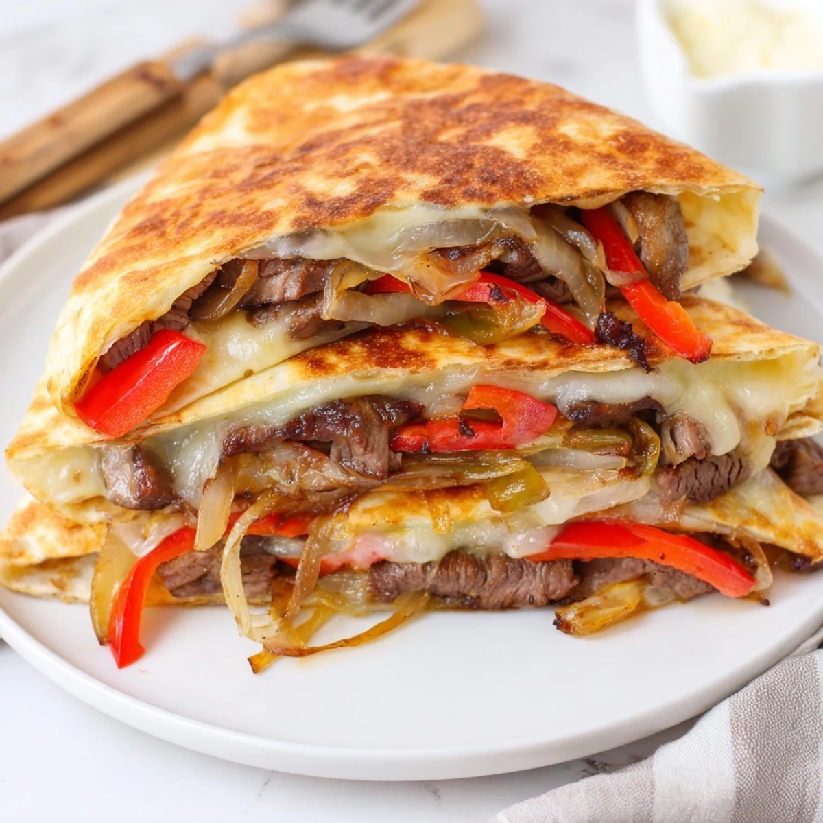 Crispy Steak Cheese Tortilla Melts steaming on plate, golden edges, melty cheese.