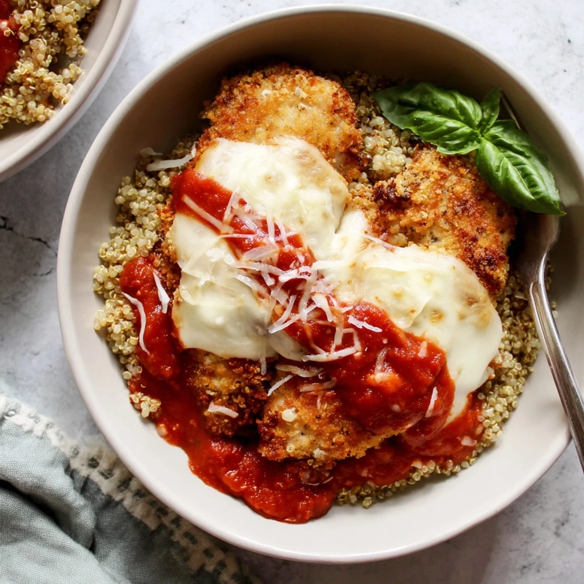 Sliced Super Yummy Cottage Cheese Chicken Parm Bowl topped with broiled bubbly mozzarella