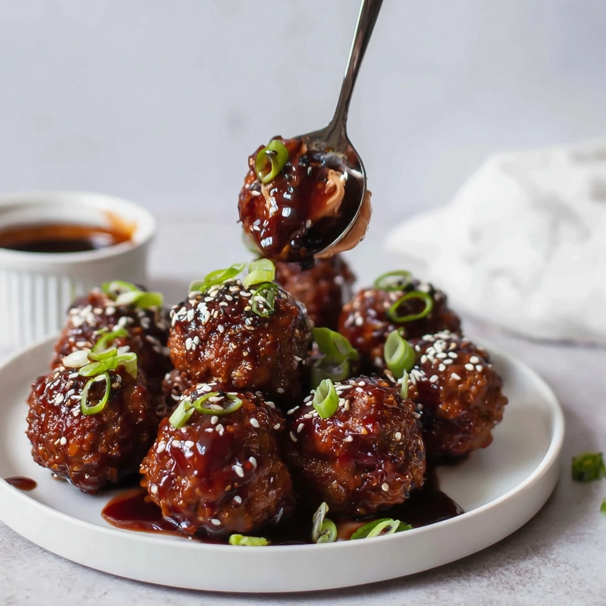 Baked Korean BBQ Meatballs With Spicy Mayo Dip, steaming and sprinkled with green onions