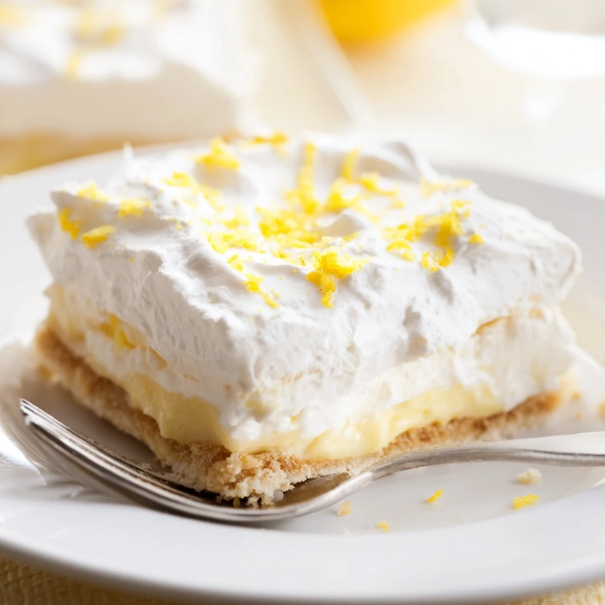 Creamy layered Lemon Lush Cake dessert with golden crust, smooth lemon filling, and soft whipped topping