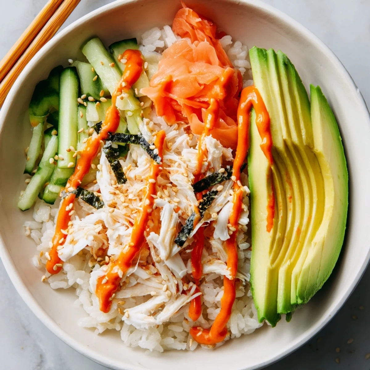Deconstructed California Roll Sushi Bowls tossed with spicy mayo, crunchy cucumber ribbons