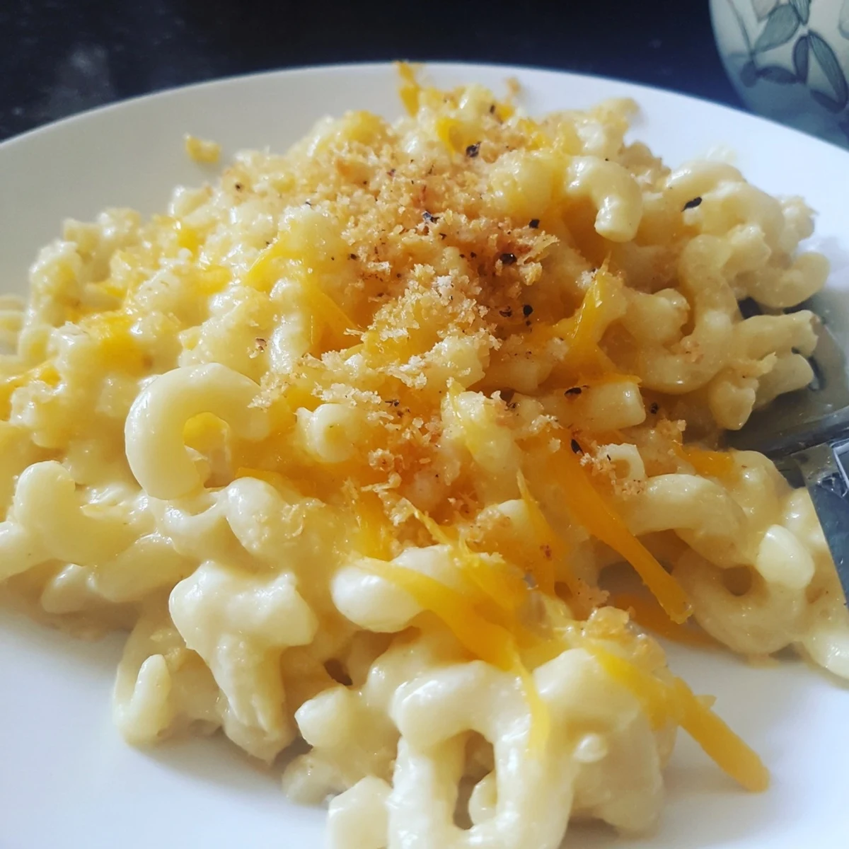 Creamy Mac And Cheese bubbling with sharp cheddar, steam rising, comfort food.