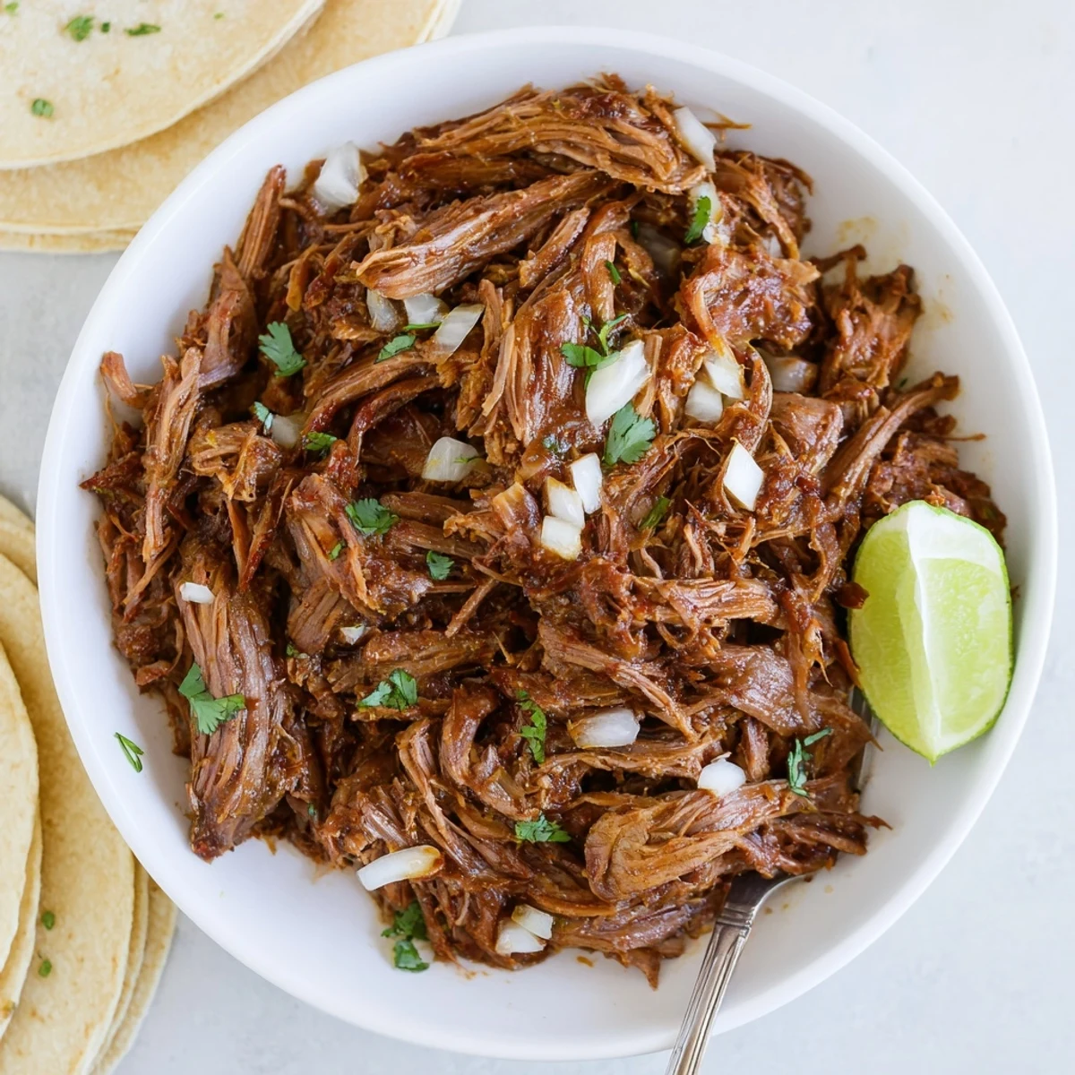 Shredded Slow Cooker Beef Barbacoa bubbling in savory juices, ready for tacos