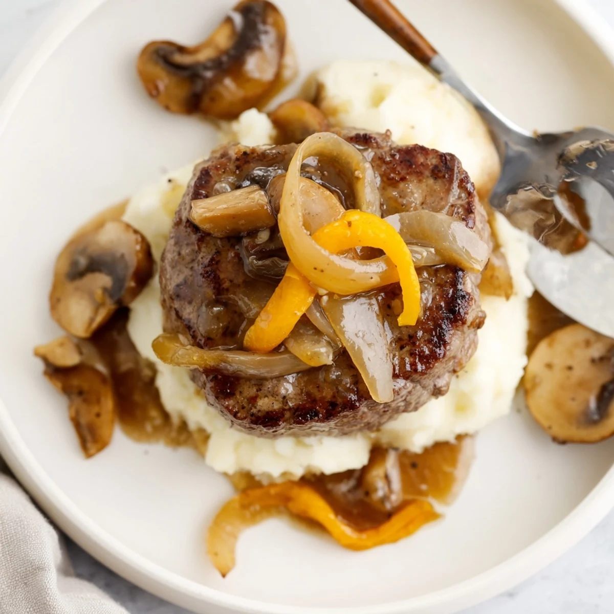Warm Country Style Smothered Cube Steak Recipe tender steaks nestled in creamy gravy