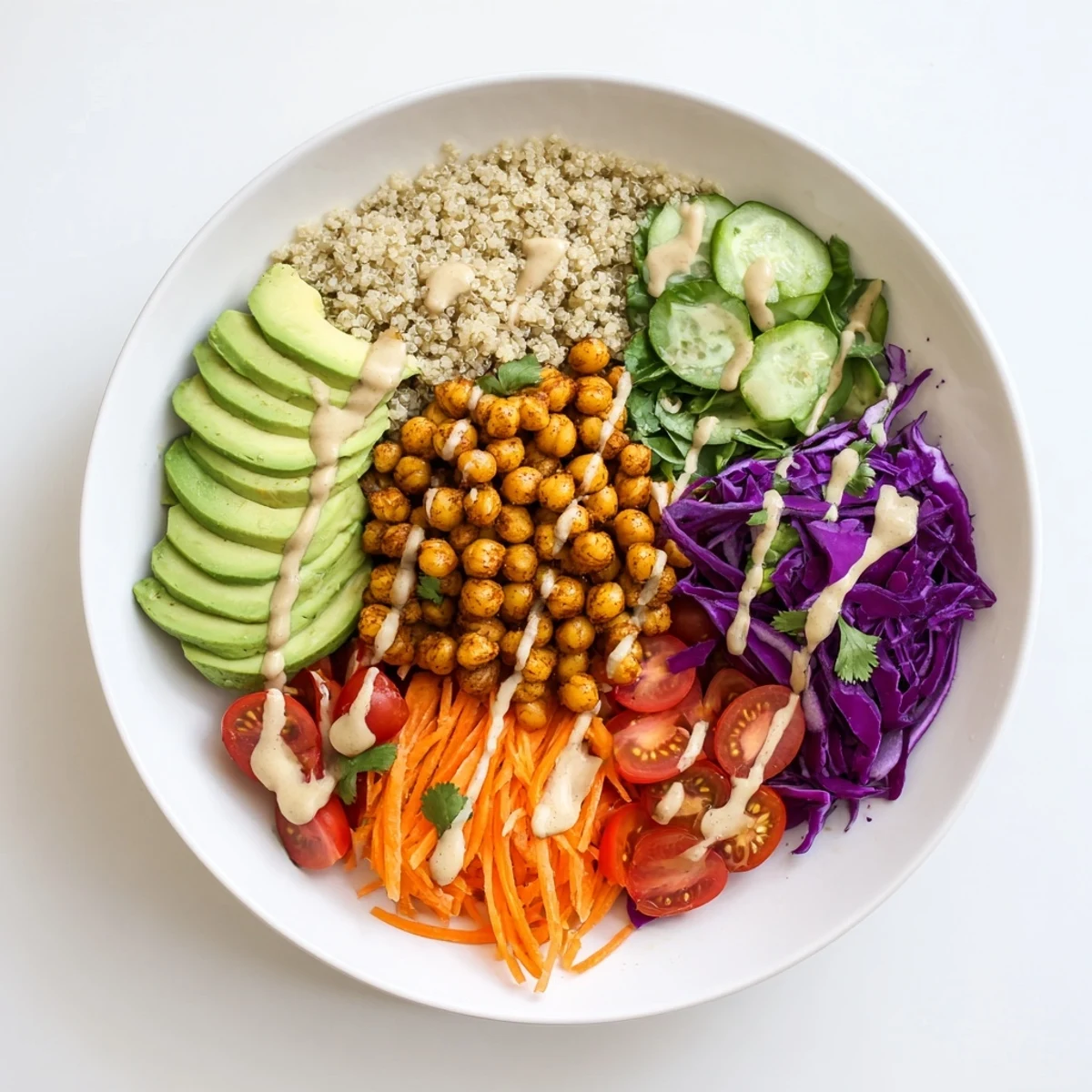 Buddha Bowl topped with fluffy quinoa, creamy tahini dressing, and toasted sesame seeds
