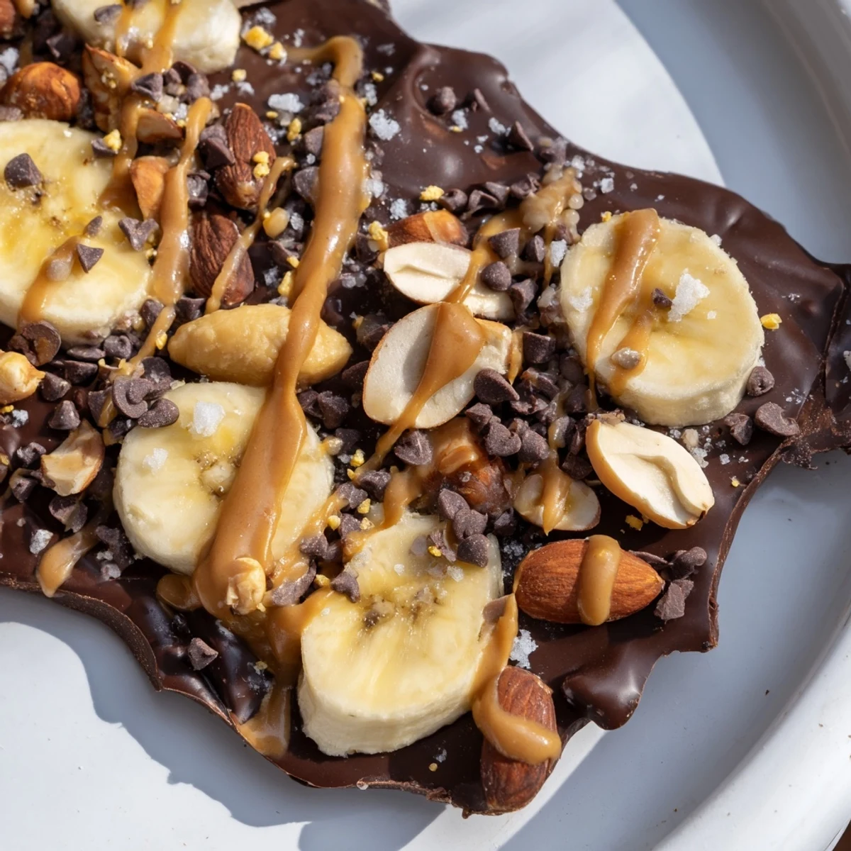 Glossy chocolate banana bark broken into rustic shards sprinkled with sea salt