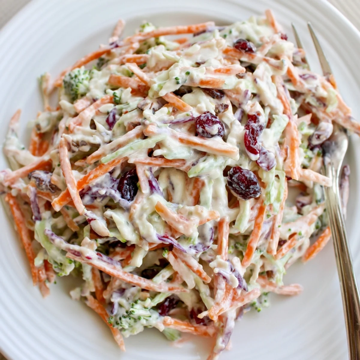 Creamy broccoli slaw tossed with cranberries and sunflower seeds in a tangy dressing
