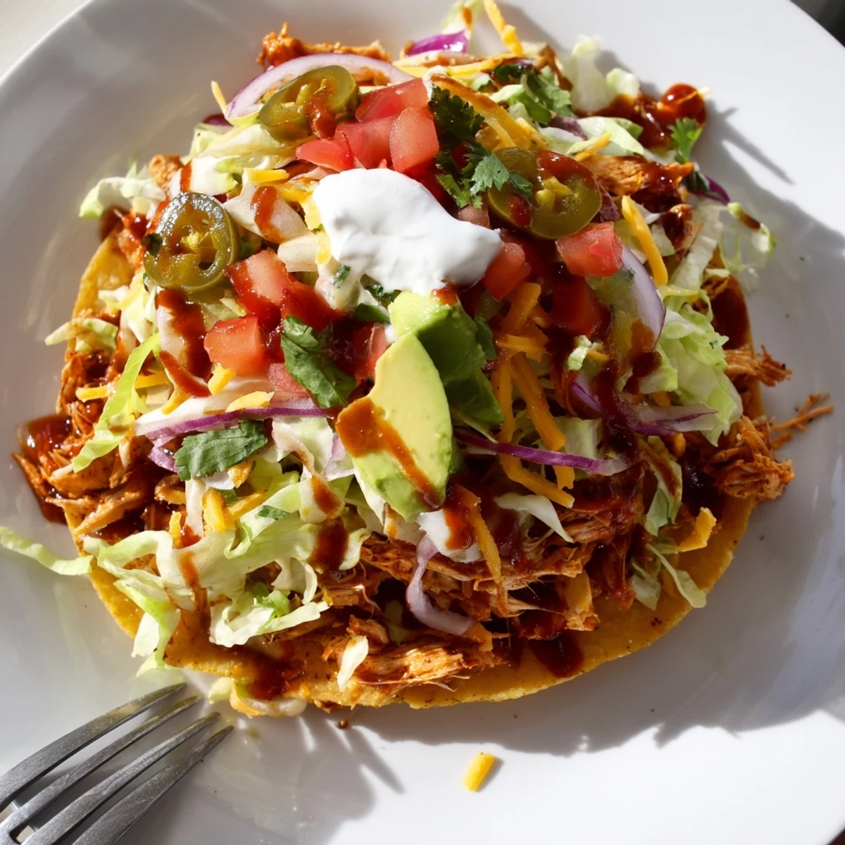 Golden corn tostadas topped with tender sweet smoky BBQ chicken and creamy avocado slices