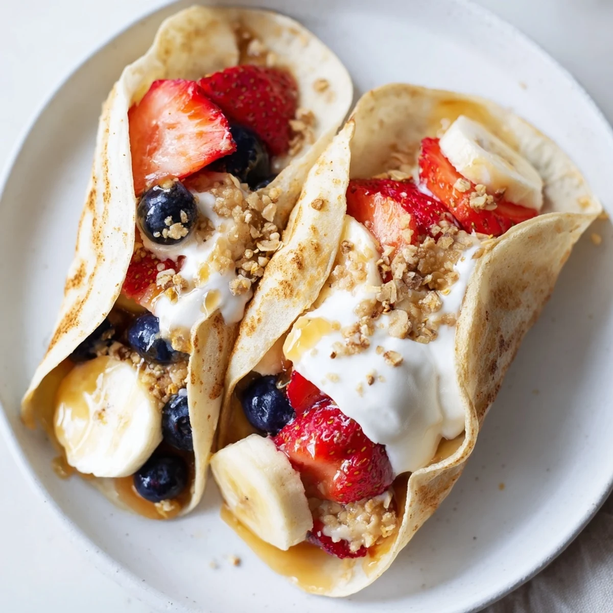 Fluffy pancake tacos folded around scrambled eggs, bacon, and melted cheddar cheese