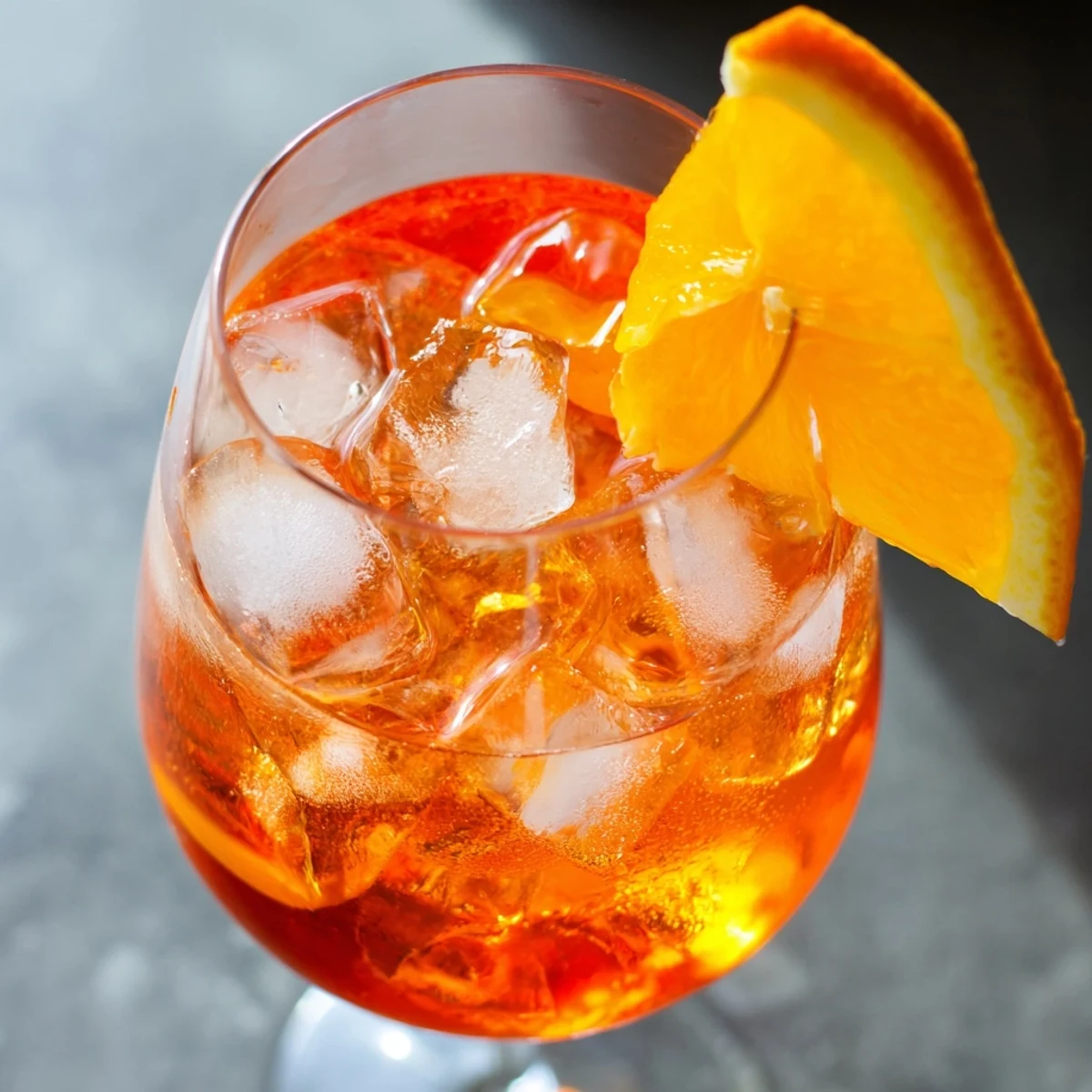 Refreshing Spritz cocktail with ice, Prosecco, Aperol, soda, and an orange garnish.  