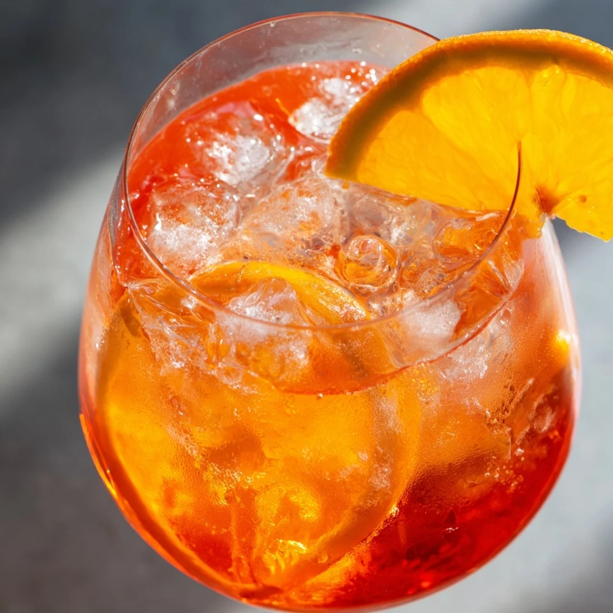 Vibrant Italian Spritz featuring sparkling Prosecco, Aperol, soda water, and a citrus orange wheel.