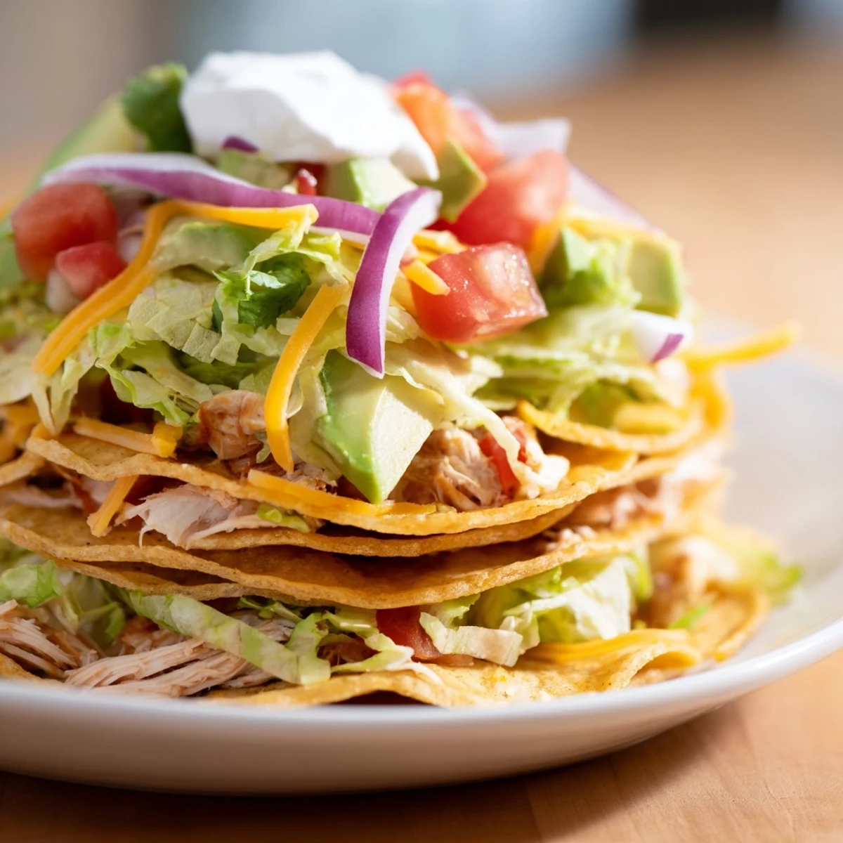 Seasoned shredded chicken served on golden corn tortillas with cheese and avocado.  