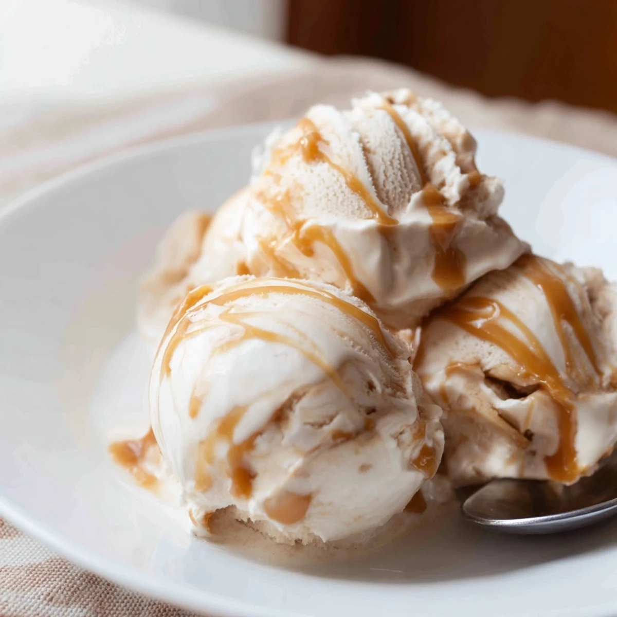 Creamy no churn salted caramel ice cream recipe with rich caramel swirls in a bowl.  