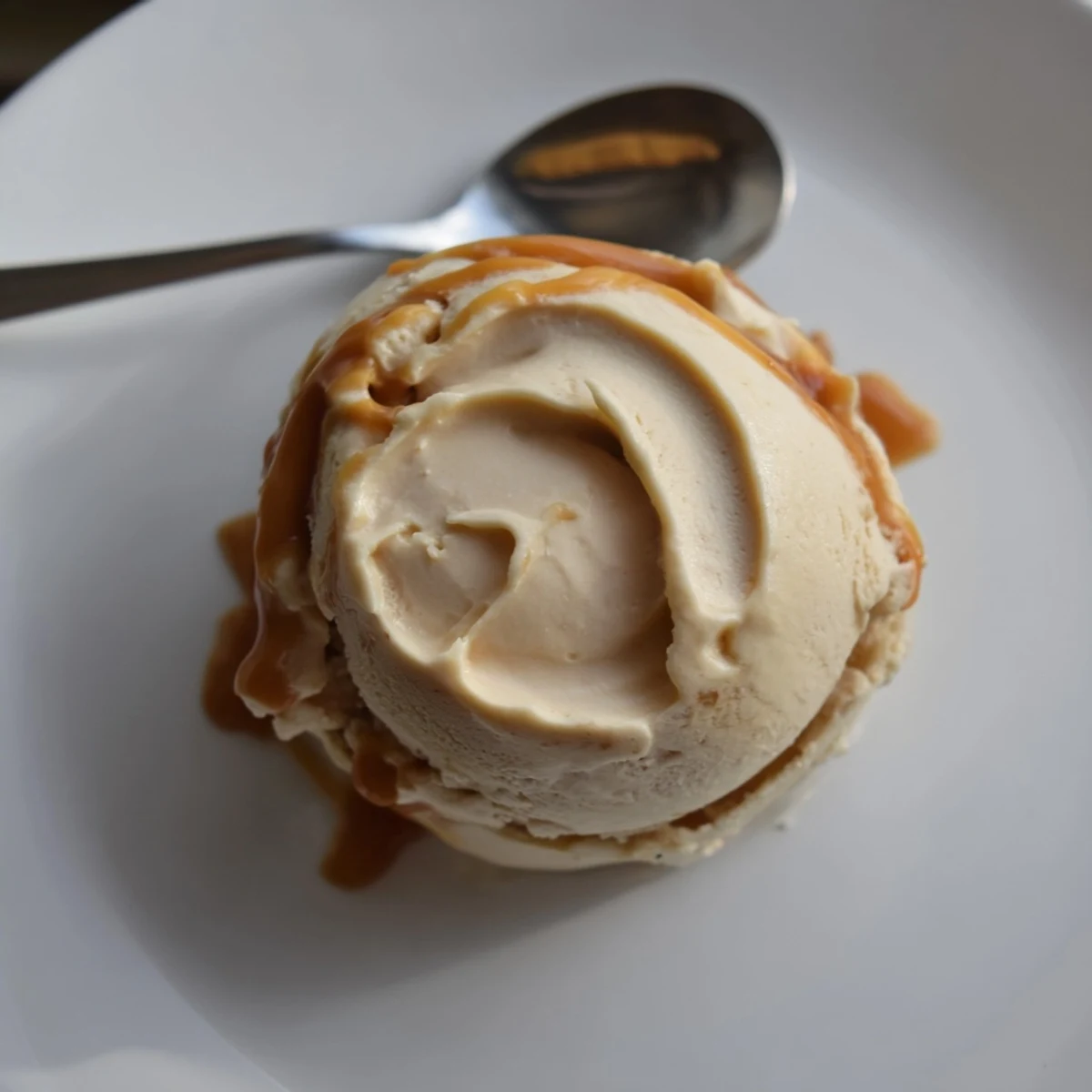 Homemade no churn salted caramel ice cream recipe served in a chilled glass bowl.