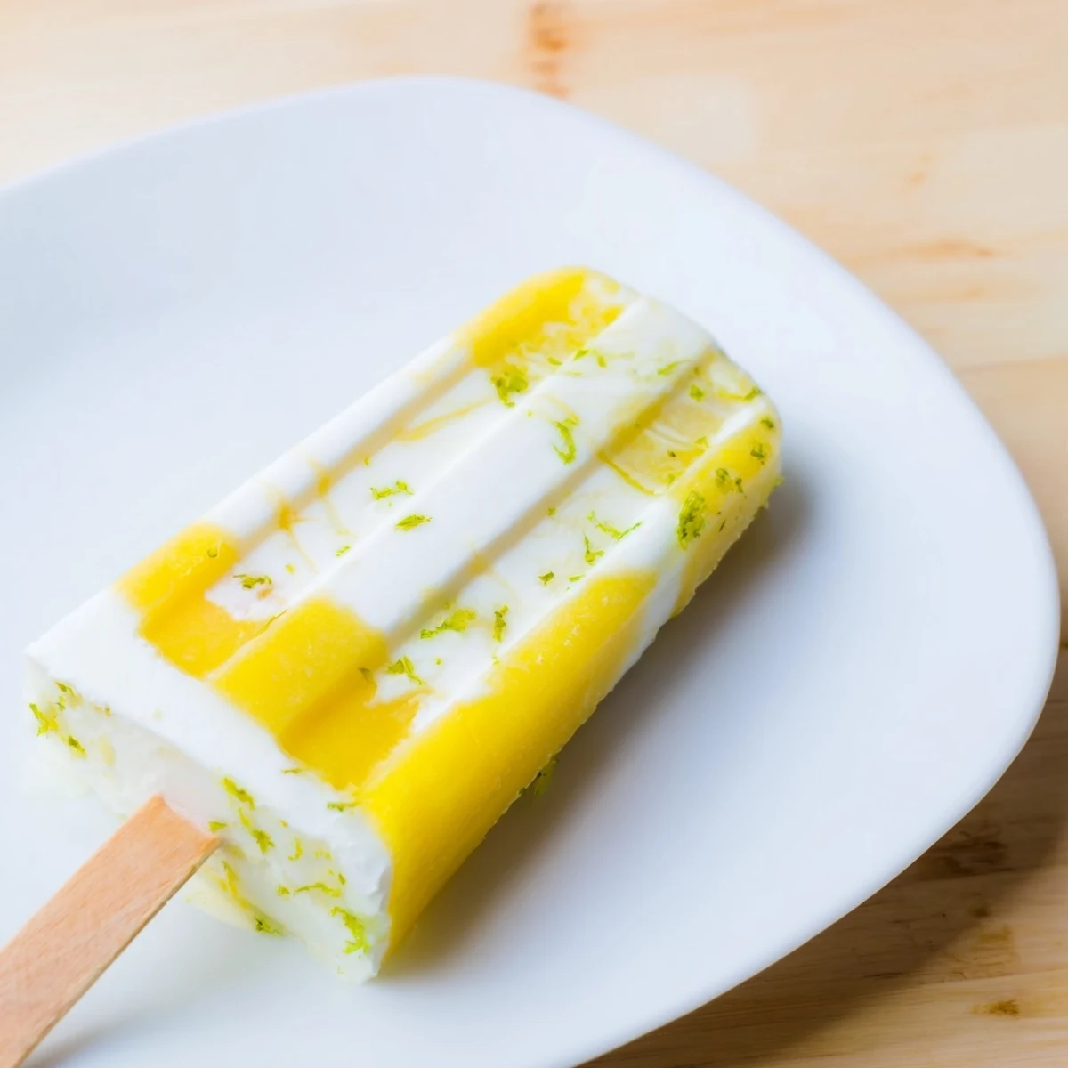 Tropical vegan popsicles featuring creamy coconut layers and zesty lime accents  