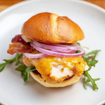 Glistening maple glazed chicken topped with crunchy bacon and fresh arugula on soft slider buns