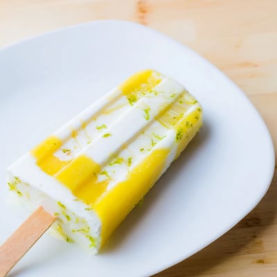 Tropical vegan popsicles featuring creamy coconut layers and zesty lime accents  